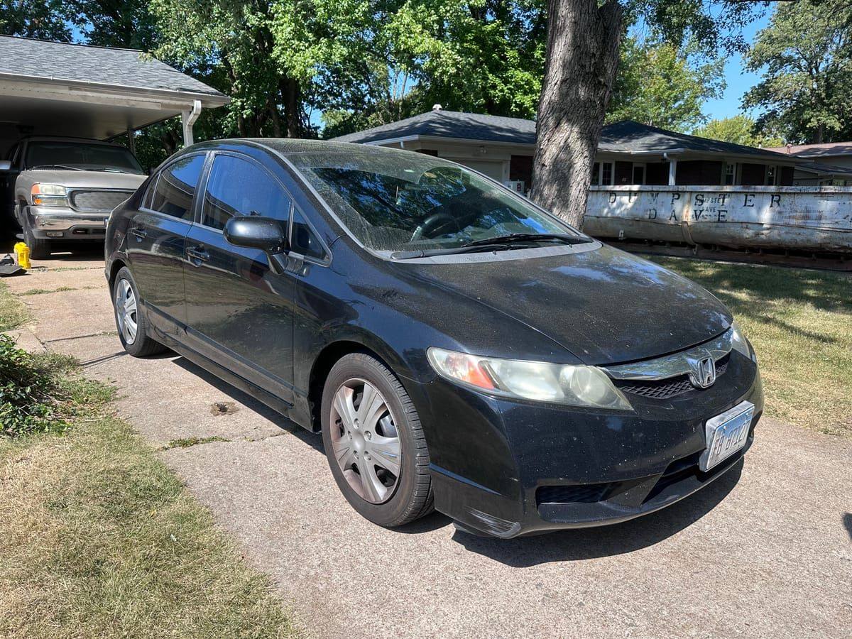 Black Honda Civic with dull, dusty neglected paint before detailing