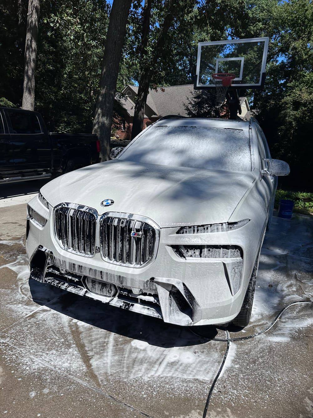 BMW X7 covered in foam during a mobile exterior detail at a Belleville driveway