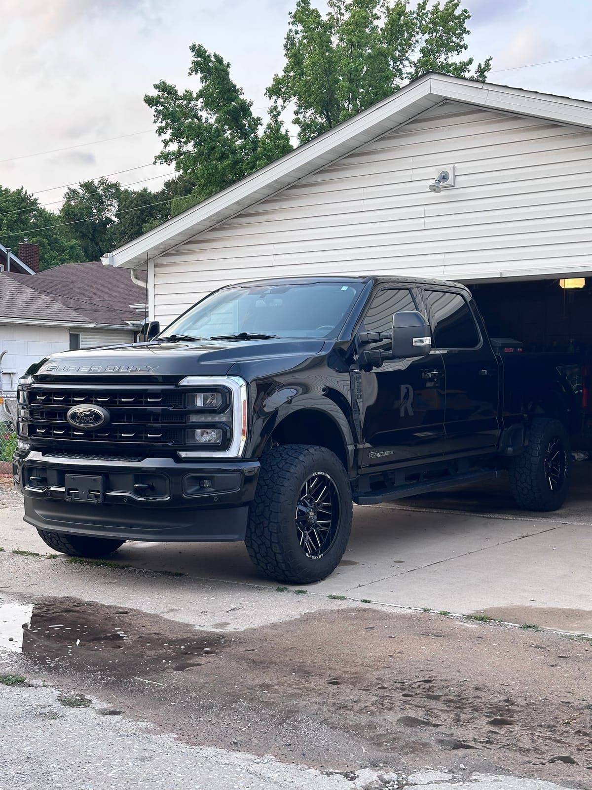 Lifted black Ford Super Duty with glossy paint after a full detail