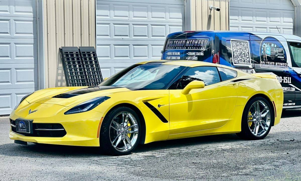 Yellow Corvette Stingray with glossy paint after detailing, Polished Midwest van in the background