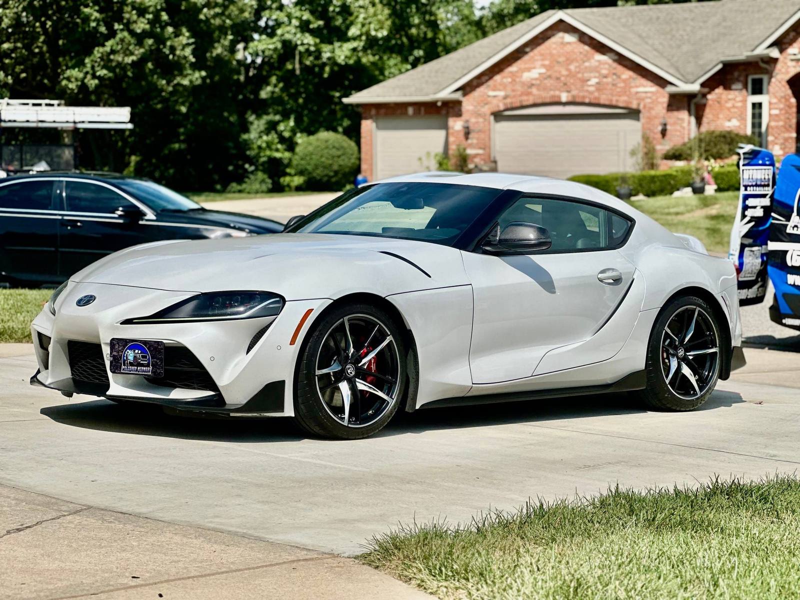 Freshly detailed white Toyota Supra with glossy paint in a Belleville, IL driveway — mobile detailing by Polished Midwest